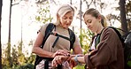 Hiking, smart watch and tracking with people in forest for adventure guide, wildlife conservationist or navigation. National park, environment and trail mapping with women in nature for field explore
