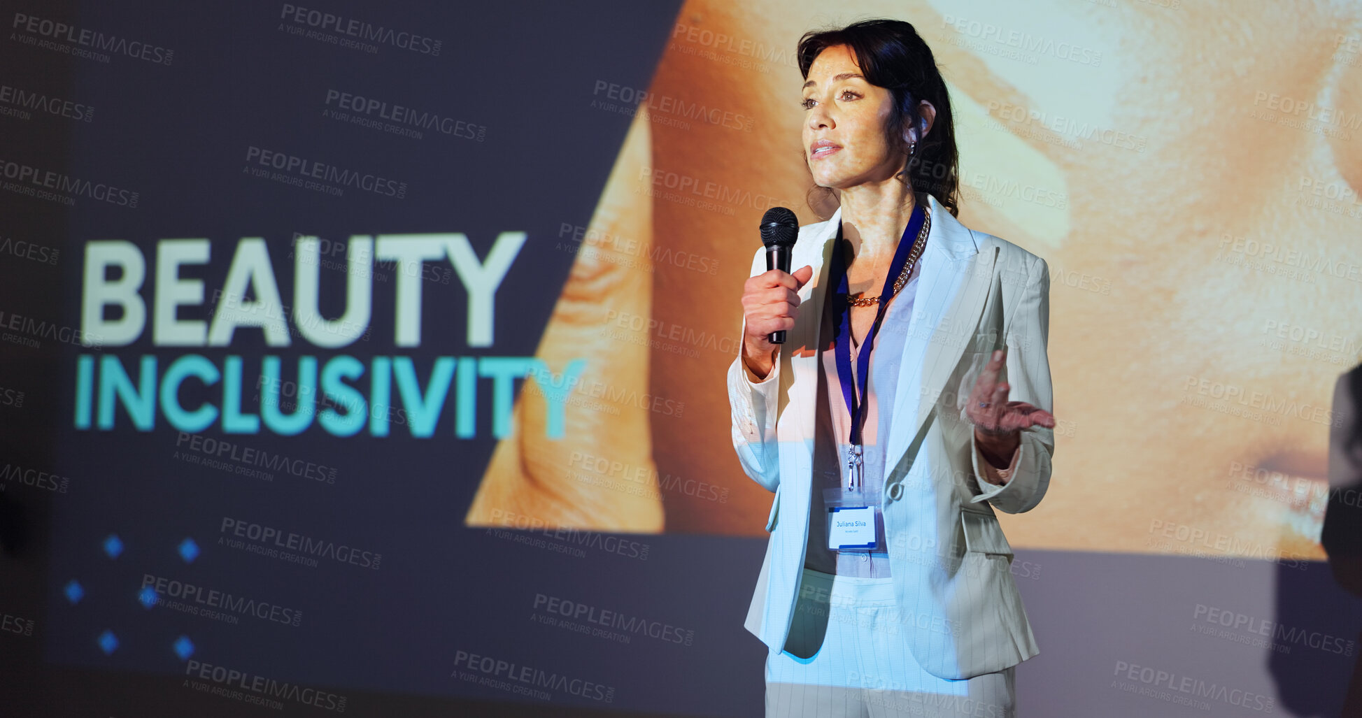 Buy stock photo Woman, presentation and speaker at conference with beauty, inclusivity or stage with mic for skincare. Person, speech and announcement for makeup, cosmetics or information at international convention