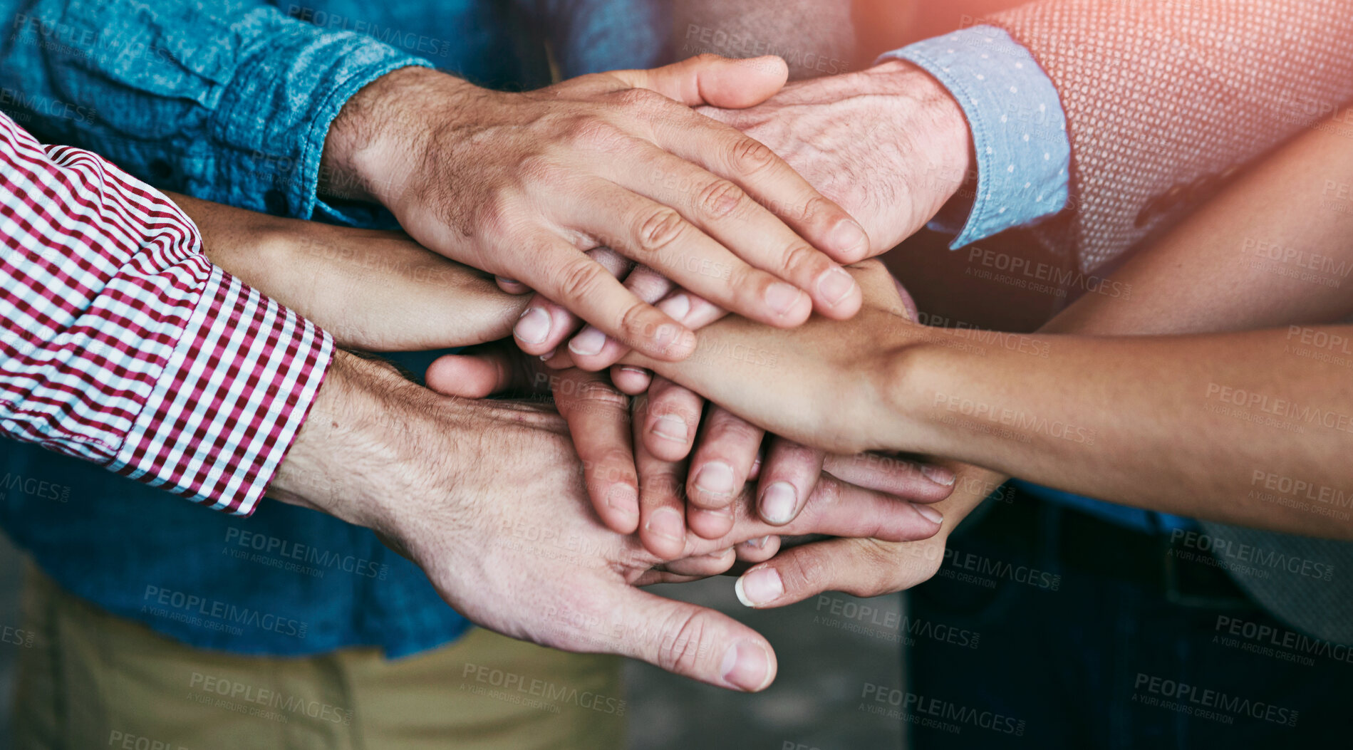 Buy stock photo Teamwork, collaboration and support while putting hands together in an office for motivation and unity amongst colleagues. Group of businesspeople standing together in a huddle during team building