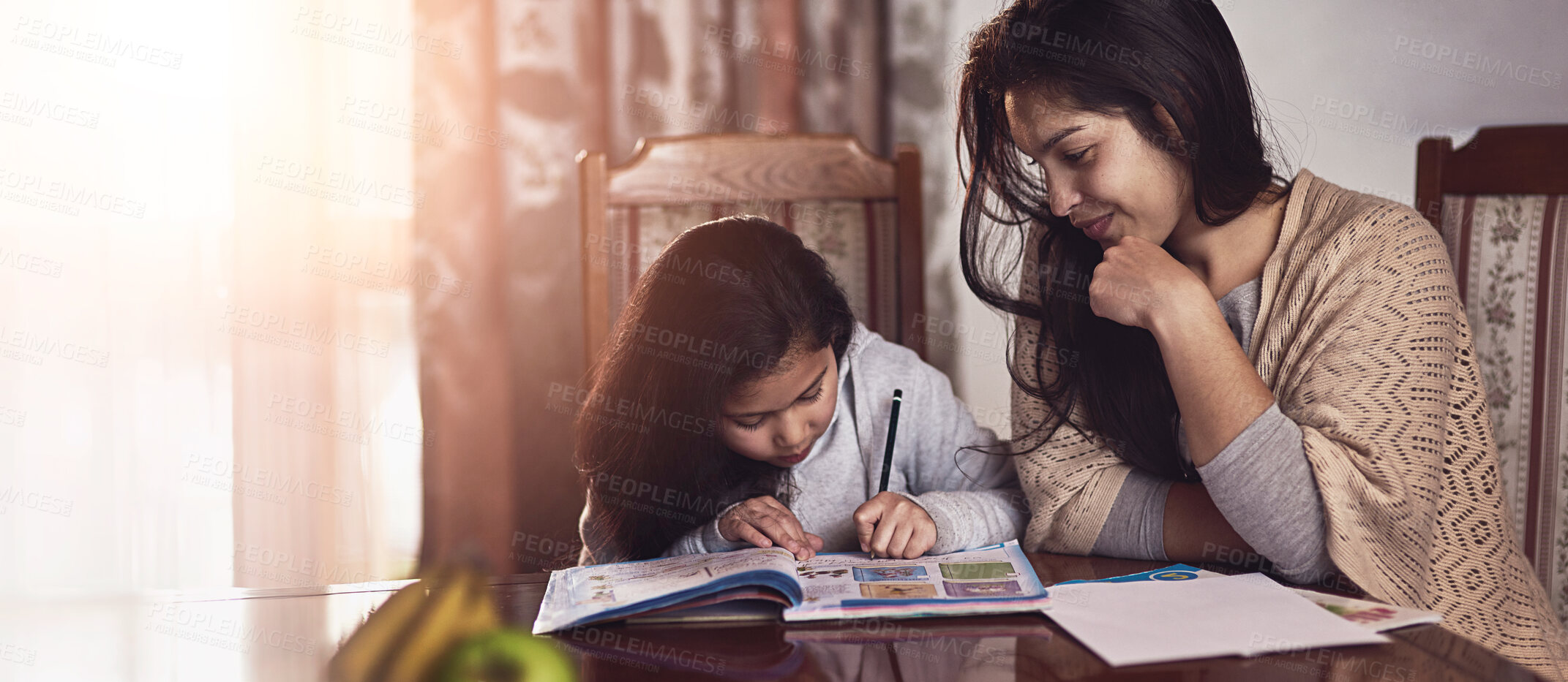 Buy stock photo Shot of a mother watching her daughter do her homework at home