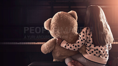 Buy stock photo Rear view shot of a little girl sitting in front of a piano with her teddy bear