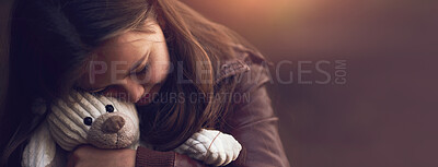 Buy stock photo Cropped shot of a young girl hugging her teddy bear outside