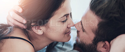 Buy stock photo Shot of an affectionate couple lying on their bed