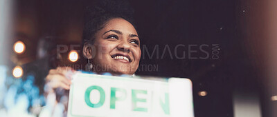 Buy stock photo Cropped shot of a young woman hanging up an 