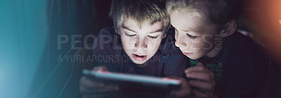 Buy stock photo Shot of siblings using a digital tablet under their fort at home