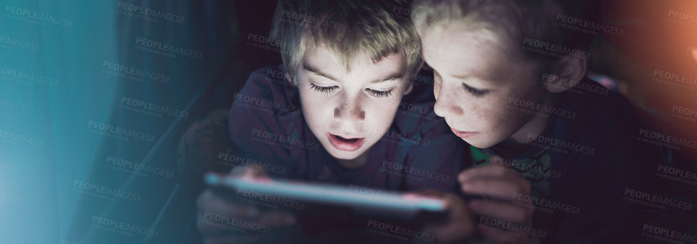 Buy stock photo Shot of siblings using a digital tablet under their fort at home