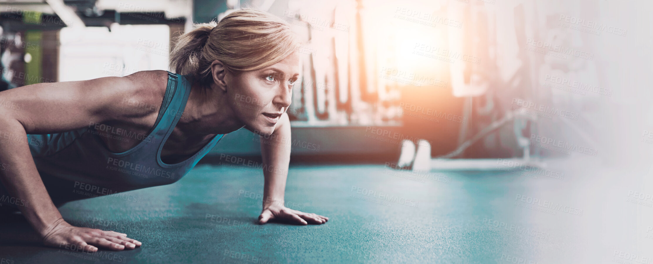 Buy stock photo Shot of a sporty woman working out at the gym