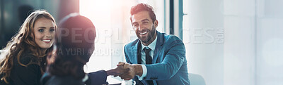 Buy stock photo Cropped shot of businesspeople shaking hands during a meeting in an office