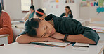 Tired, sleeping and student on desk in classroom at school with fatigue in lesson for learning. Burnout, rest and girl teenager with nap for exhaustion with education, learning or studying for exam.