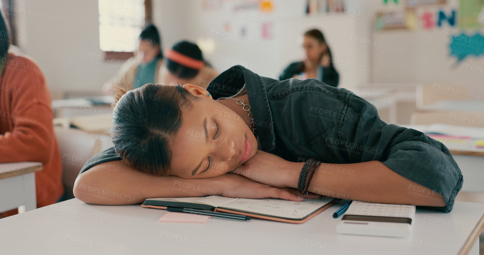 Buy stock photo Tired, sleeping and student on desk in classroom at school with fatigue in lesson for learning. Burnout, rest and girl teenager with nap for exhaustion with education, learning or studying for exam.