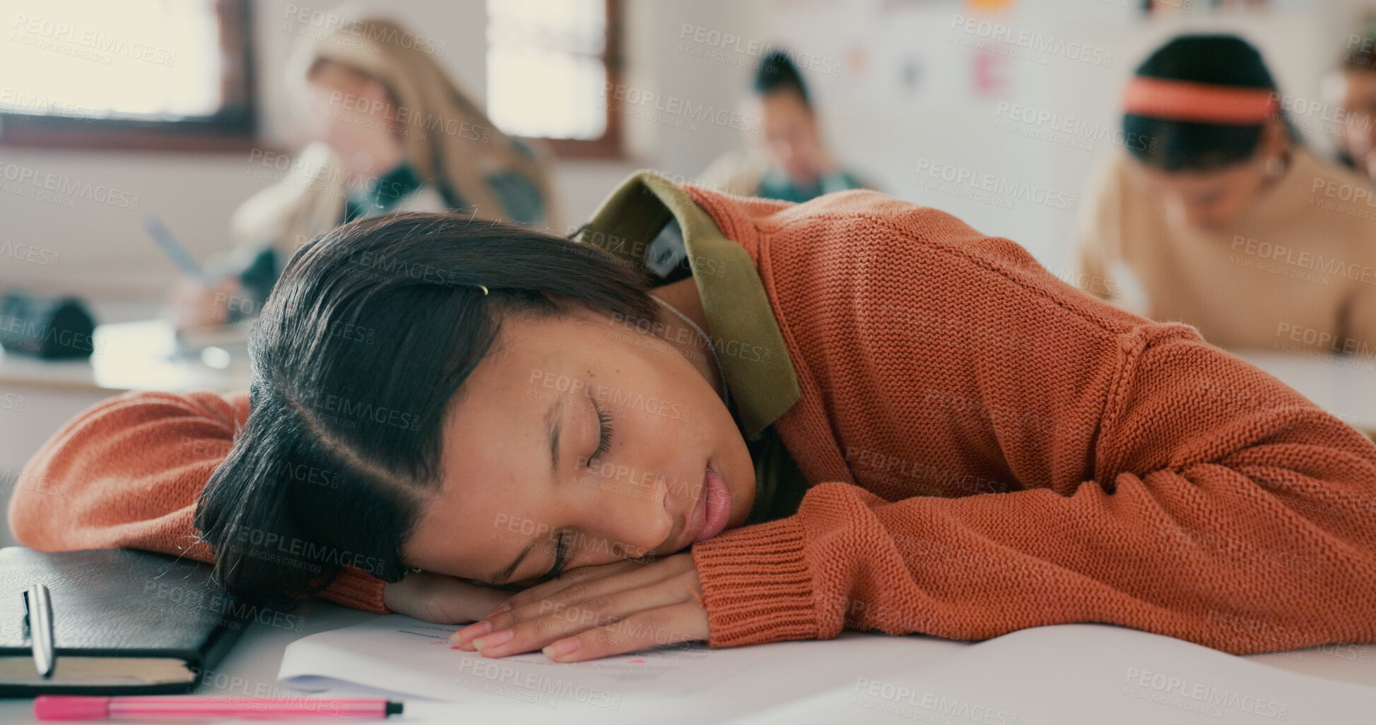 Buy stock photo Tired, sleeping and girl on desk in classroom at school with fatigue in lesson for learning. Burnout, rest and teenager student with nap for exhaustion with education, learning or studying for exam.