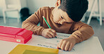 Boy, child and writing with paper at school for education, learning and assessment for progress at academy. Kid, quiz and activity for development, scholarship and thinking with language in classroom