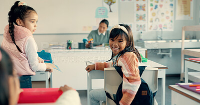 Buy stock photo Girl, child and talking to friends in classroom with joke, distraction and funny at academy for education. School kids, playful and learning with development, scholarship and knowledge for progress