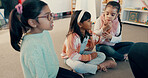 Students, girl and children on floor in classroom for reading group, learning and academic development. Kindergarten, kids and learner on ground at school for study activity, education or scholarship