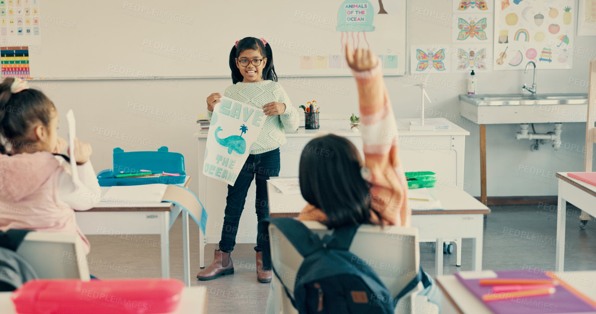 Buy stock photo Happy girl, classroom and presentation with poster or question for global warming, ocean conservation or awareness at school. Young kid, child or elementary student with sign for eco friendly planet