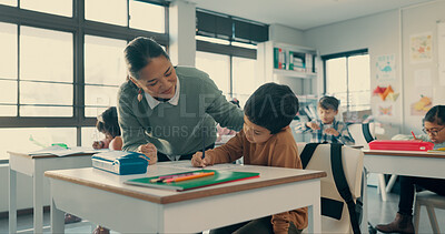 Buy stock photo Help, teacher and student in classroom with notebook, growth and child development in education. Learning, woman and boy at desk together with support, writing and exam notes at elementary school