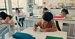 Student, boy and child with writing in classroom for literacy skills, learning development and school lesson. Learner, person and educational assessment at academy for knowledge, scholarship or study