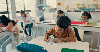 Buy stock photo Student, boy and child with writing in classroom for literacy skills, learning development and school lesson. Learner, person and educational assessment at academy for knowledge, scholarship or study