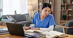 Nurse, woman and studying with books by laptop for medical research, information and knowledge. Healthcare, worker and reading with technology at desk for diagnosis reference, guide or treatment plan