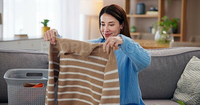 Buy stock photo Laundry, housework and woman on sofa with smile, washing basket and home management in living room. Housekeeping, chores and happy housewife on couch folding fresh clothes, cleaning and morning care