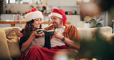 Buy stock photo Christmas, happy couple and hug on sofa with hot chocolate, coco and relax in home. Man, woman and eggnog in living room for comfort, warmth and enjoy festive season in winter with love and support