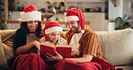 Christmas, family and happy on couch with book, funny storytelling or reading together. Parents, child and support in home with novel, literature humor and love at festive season with comedy on couch