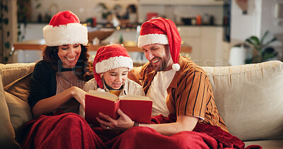 Buy stock photo Christmas, family and happy on couch with book, funny storytelling or reading together. Parents, child and support in home with novel, literature humor and love at festive season with comedy on sofa