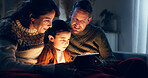 Christmas, bonding and family with tablet, night and watching movies in dark, child and parents in home. Digital, man and woman with son, festive and film for season, celebration and holiday in house