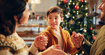 Buy stock photo Family, prayer and holding hands in home for Christmas, solidarity and gratitude with spiritual connection. Parents, boy and worship in living room for thanks, faith and vacation as Christian people