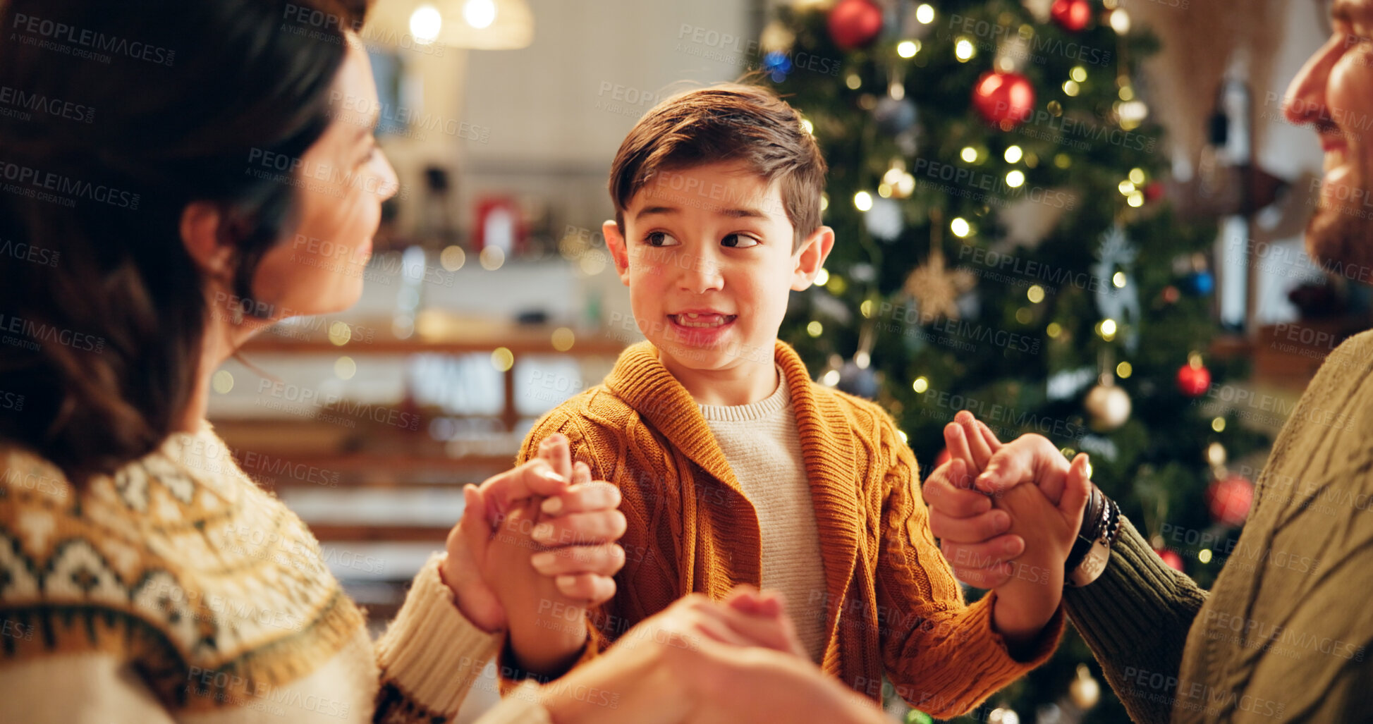 Buy stock photo Family, prayer and holding hands in home for Christmas, solidarity and gratitude with spiritual connection. Parents, boy and worship in living room for thanks, faith and vacation as Christian people