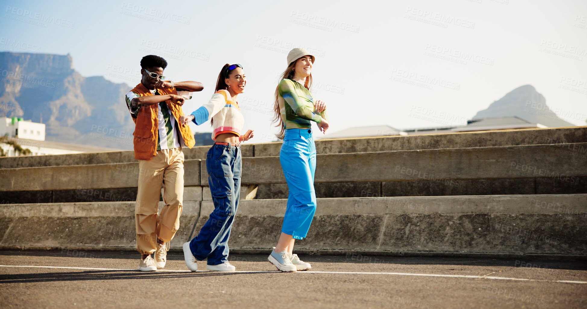 Buy stock photo Urban, fun and group of happy people with dance, diversity and cool streetwear style at sunset. Excited, smile and gen z friends with city fashion, positive energy and bonding in street together.