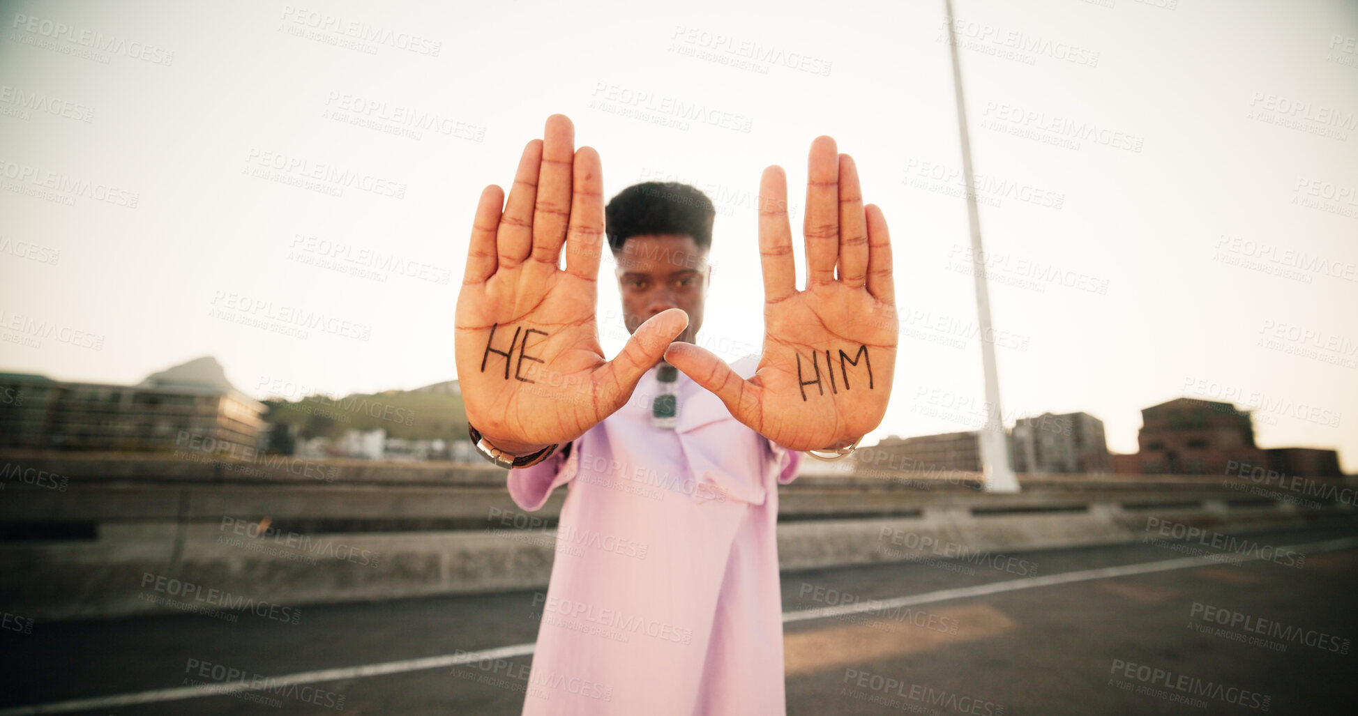 Buy stock photo Hands, pronouns and person with he, him and outdoor for gender identity, inclusion or sexuality with opinion in street. Portrait, equality and palm with writing, voice or sign for announcement in USA