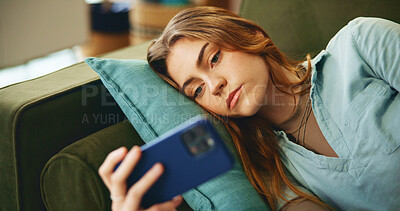 Buy stock photo Sad, phone and woman on sofa in home for social media, online videos and streaming on internet. Upset, apartment and person with smartphone for mobile app, movies and entertainment in living room