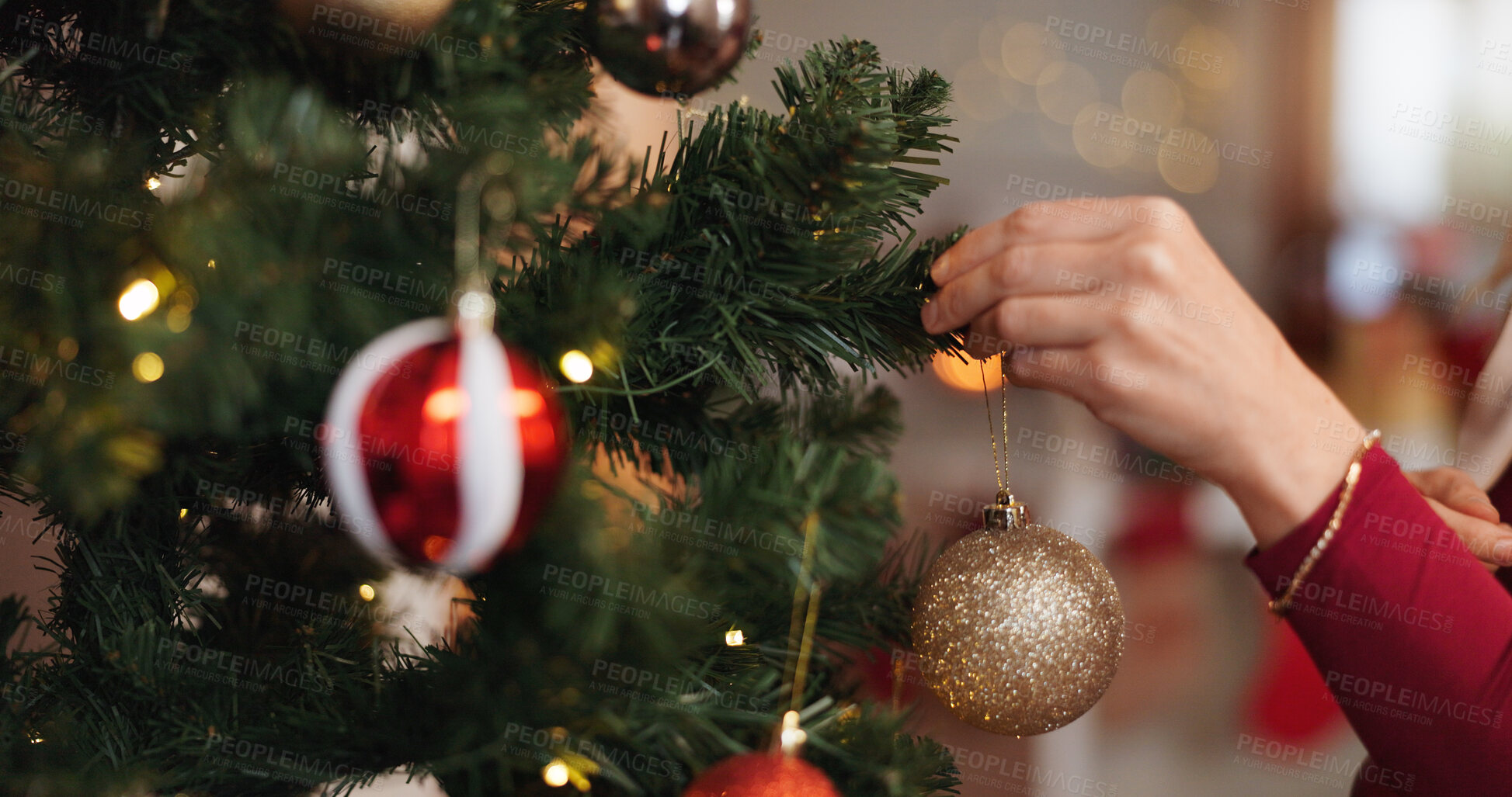 Buy stock photo Christmas, hand and tree with person and bauble for decoration, gift giving and festive season. Xmas, holiday and celebration with closeup in living room at home for tradition, noel and winter