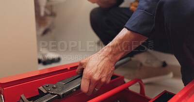 Buy stock photo Hands, man and kitchen with plumbing tools for home repairs, diy and maintenance. Male person, closeup and small business as handyman for fixing sink, pipes and renovation with uniform as contractor