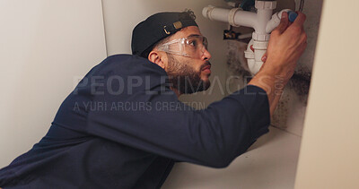 Buy stock photo Plumber, man and pipeline repair in kitchen with tools for home maintenance and fixing leak by sink. Plumbing contractor, handyman and working on filter system improvement for small business in house