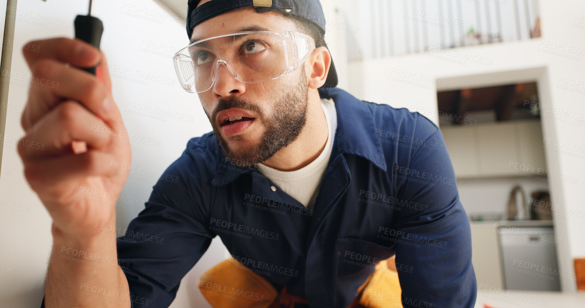 Buy stock photo Plumber, man and screwdriver for pipe in kitchen with home maintenance and fixing leak by sink with glasses. Plumbing contractor, handyman and tools for filter system installation for small business