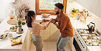 Couple, home and dancing in kitchen with music for love, bonding and meal prep with fruit. House, people and relationship with happiness or smile for healthy food, nutrition and diet with fun