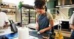 Kitchen, woman and chef with knife for onion, cutting and preparation with recipe for cooking. Restaurant, culinary service and female cook with skills for catering, small business and hospitality