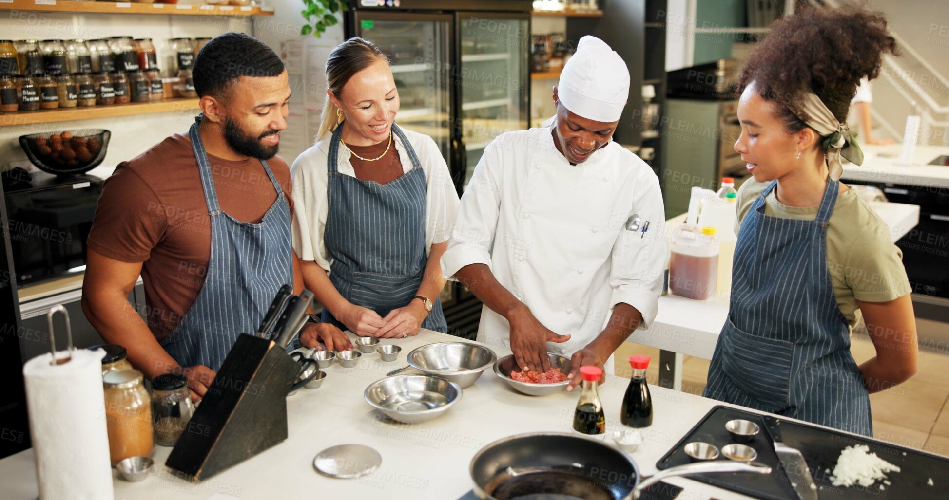 Buy stock photo Cooking, class and chef in kitchen with meat preparation, teaching gourmet meal recipe or learning. Culinary course, people or mentor with lesson on food education or cuisine knowledge in hospitality