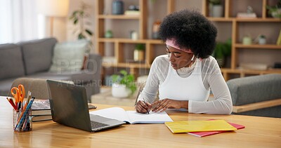 Buy stock photo Black girl, laptop and writing in home for study, online course and research project with university at table. Student, technology and learning by desk for college, education and exam notes with book