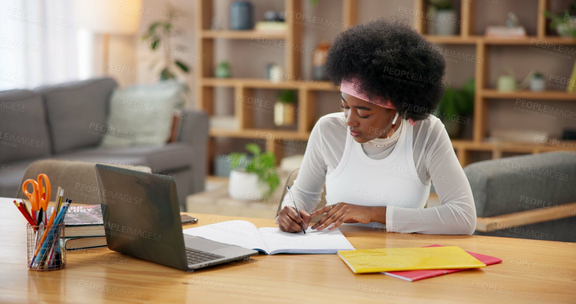 Buy stock photo Black girl, laptop and writing in home for study, online course and research project with university at table. Student, technology and learning by desk for college, education and exam notes with book