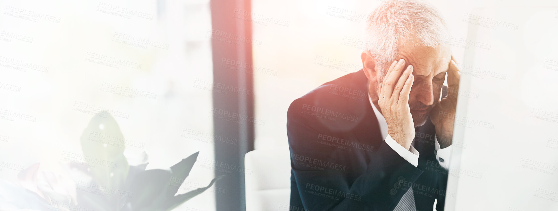 Buy stock photo Shot of a stressed out businessman working at his computer in an office