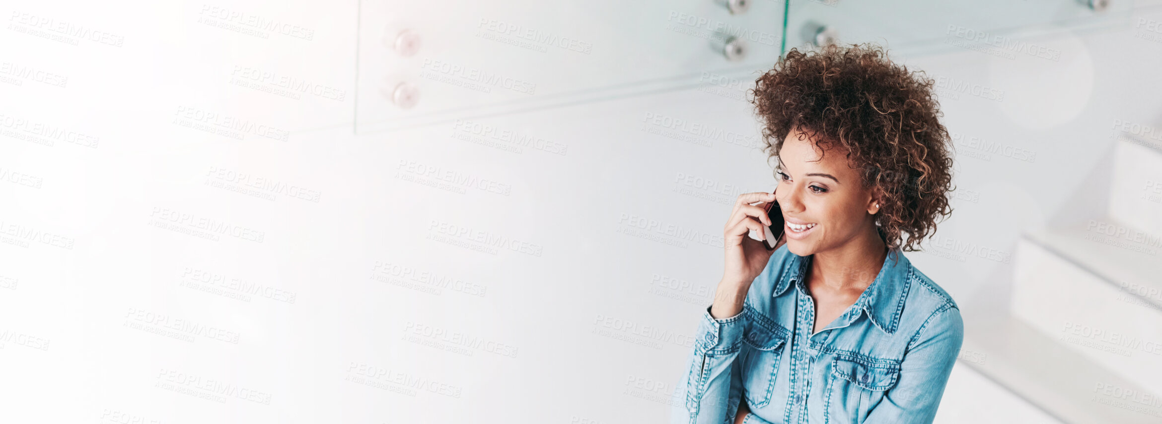 Buy stock photo Cropped shot of a young businesswoman talking on a cellphone in an office