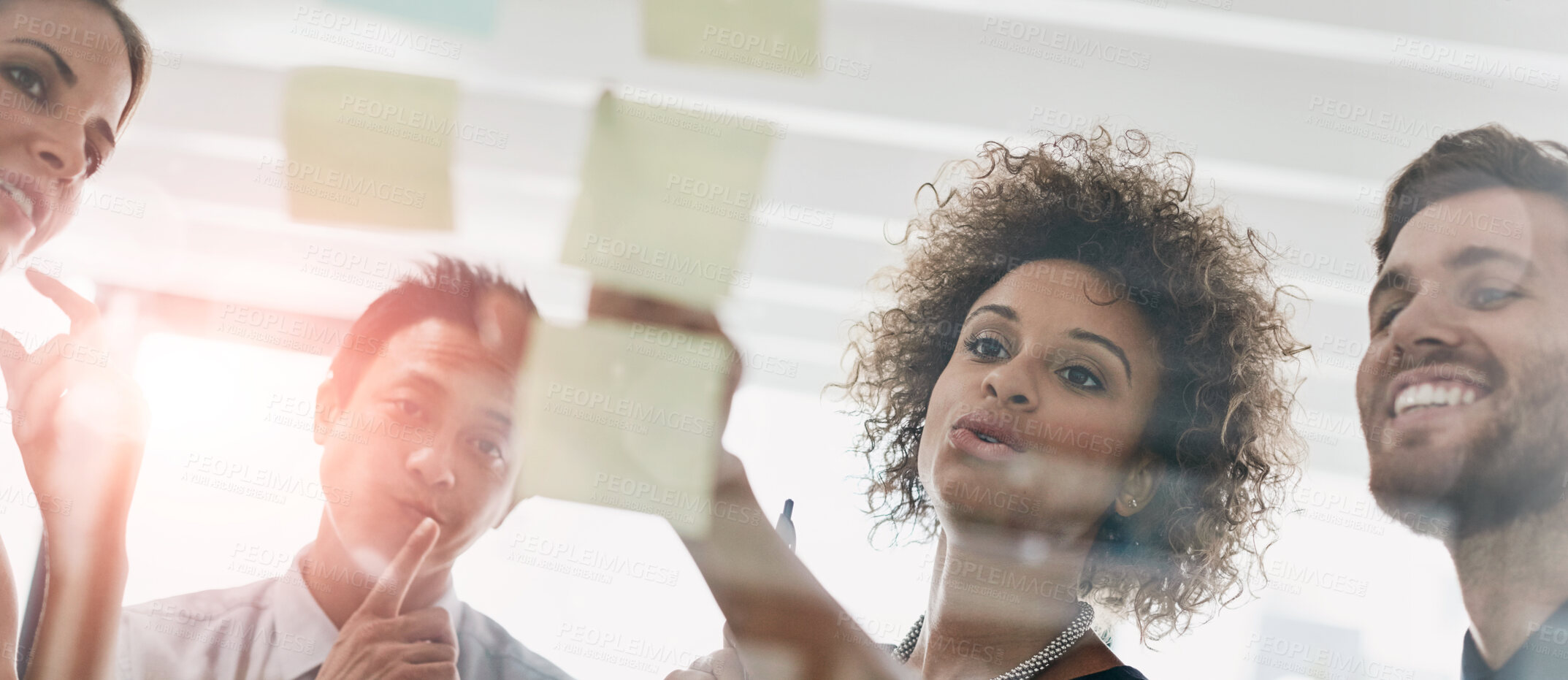 Buy stock photo Glass wall, sticky note and business people with brainstorming, teamwork and feedback in meeting. Group, employees and manager with staff, talking and cooperation for review, support or collaboration