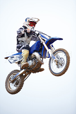 Buy stock photo Person, motorcycle and air jump in sky as professional in action, competition or fearless risk. Bike rider, off road transportation stunt or fast speed adventure at rally, extreme sport race or brave