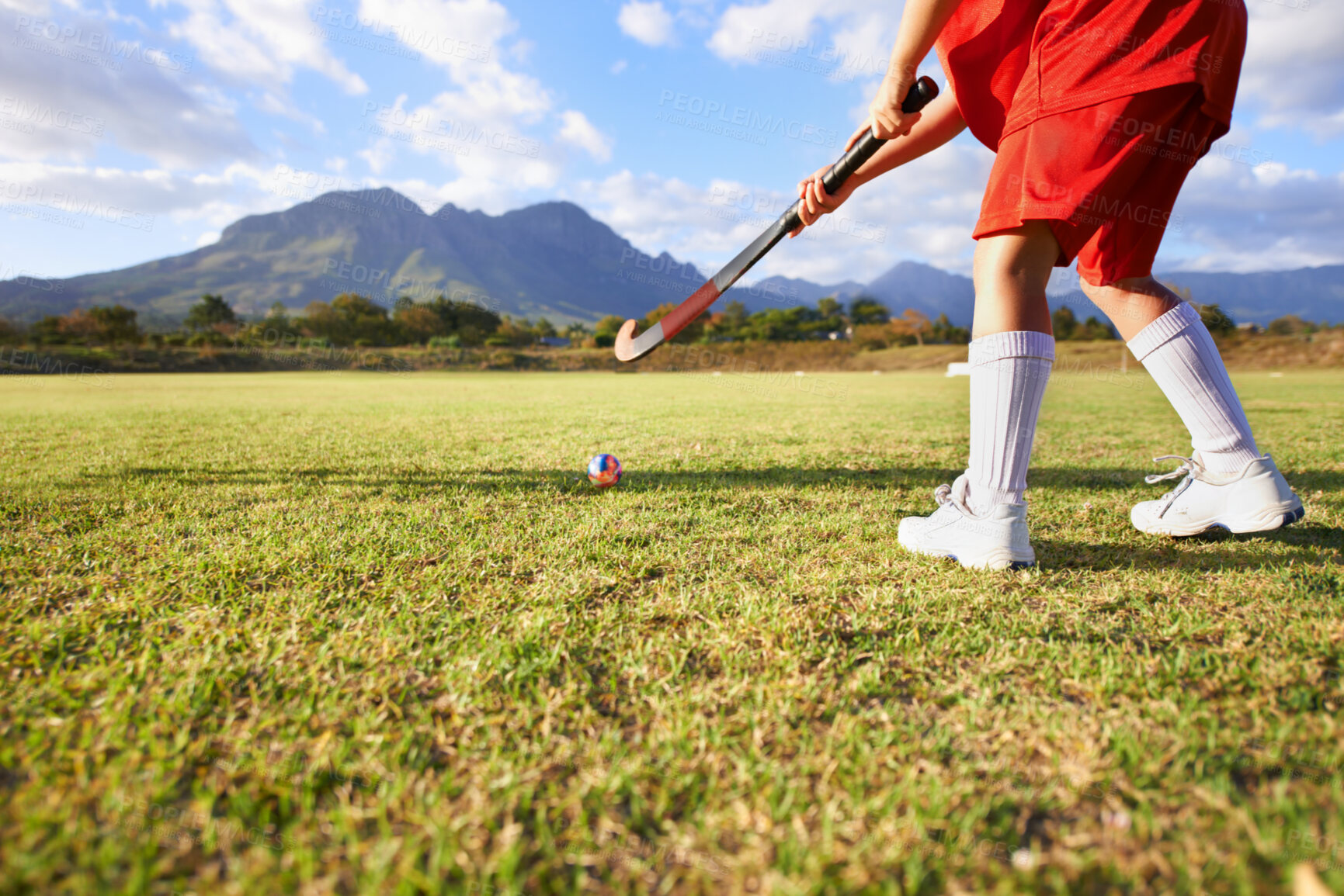 Buy stock photo Person, green grass and playing hockey for game, outdoor match or sports in nature for practice. Closeup of child, kid or player enjoying competition with ball on field for fitness training outside