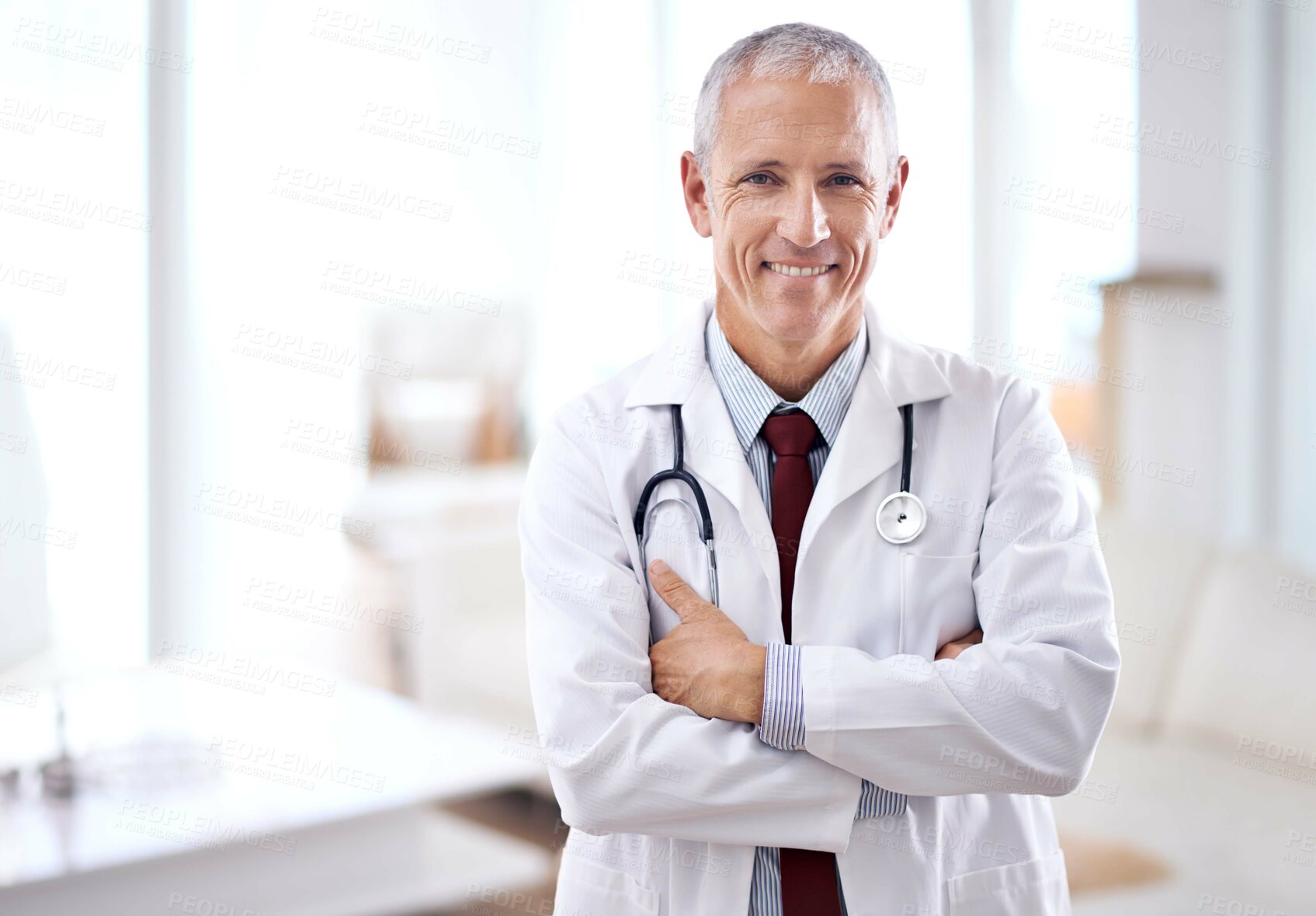 Buy stock photo Portrait of a mature medical doctor smiling at the camera