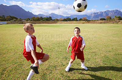 Buy stock photo Children, exercise and playing soccer on grass, practice and training for match and game in outdoors. People, kids and fitness or cardio and sports, ball and sportswear or workout together for fun