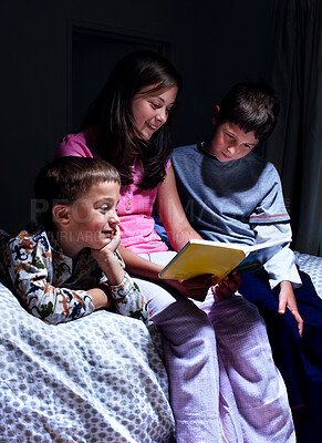 Buy stock photo Children, book and reading bedtime story, fantasy or siblings learning in dark home at night. Happy kids, family and storytelling in bedroom for education, fairytale or sister bonding with brothers